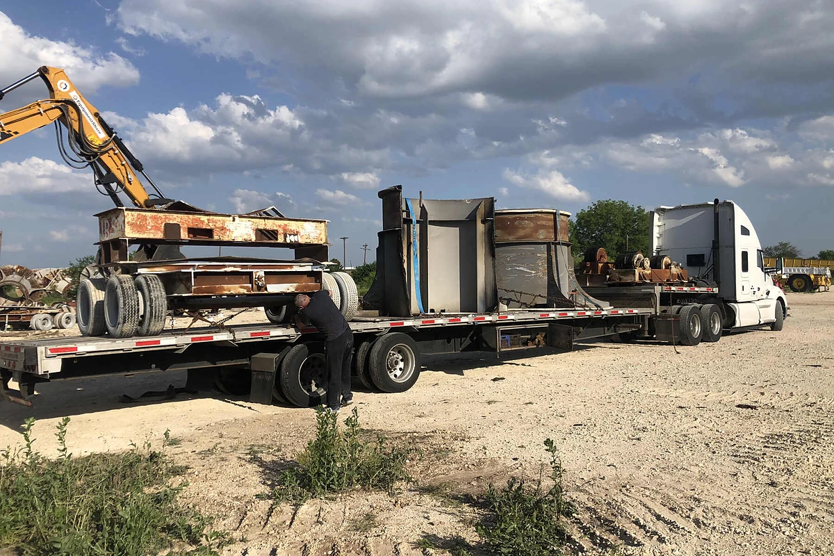 Industrial equipment secured on a flatbed for nationwide transport