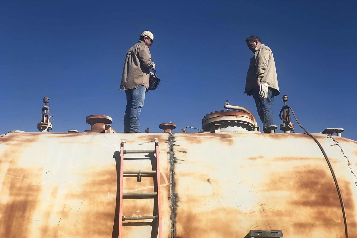 Industrial project team inspecting a large vessel